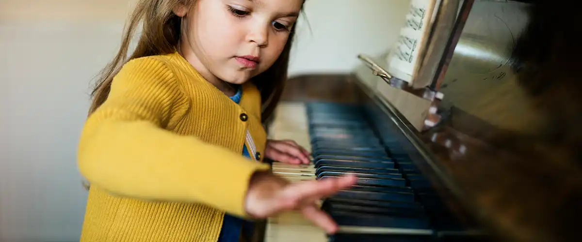 child playing music homeschool